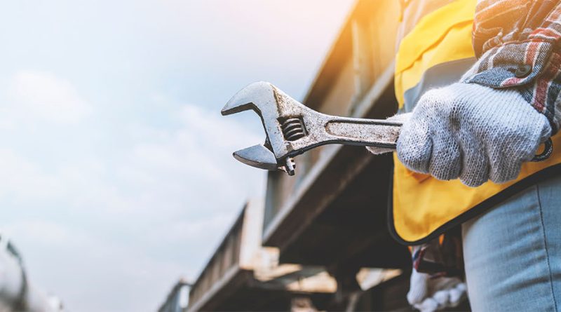 Preventative Maintenance services worker in workwear with spanner in hand