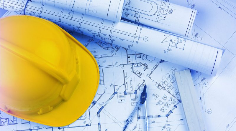 Construction planning blueprints with hard hat