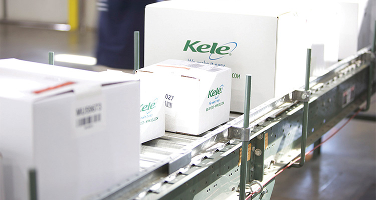 boxes from Kele Inc. moving along a conveyor belt