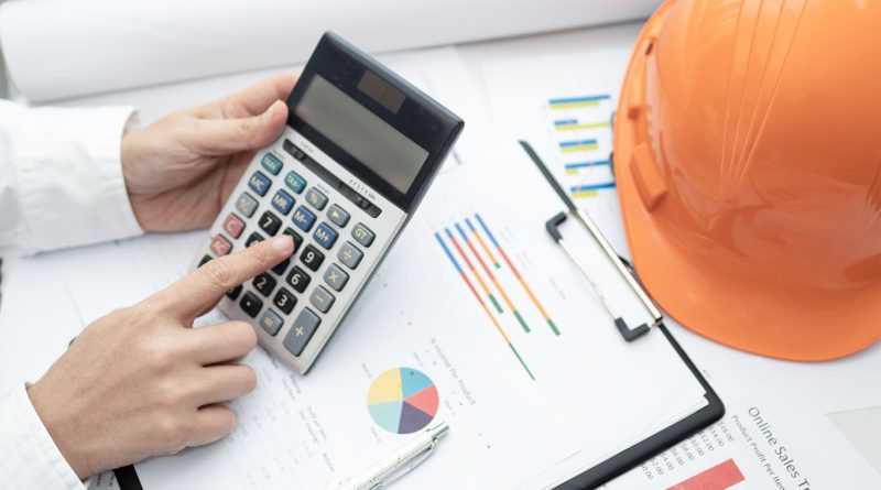 Calculator, hard hat and accounting services for construction