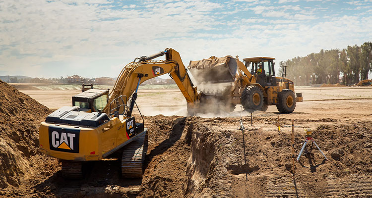 wo pieces of Caterpillar (Cat) heavy equipment on a construction site