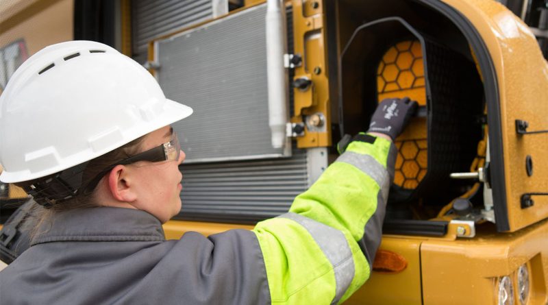 Team member at Warren CAT working on machinery