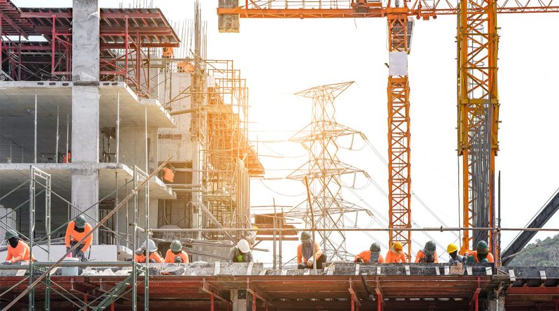 Industrial construction site with large scale facility and heavy equipment
