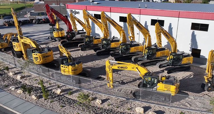 a fleet of Kobelco excavators parked at a dealership lot