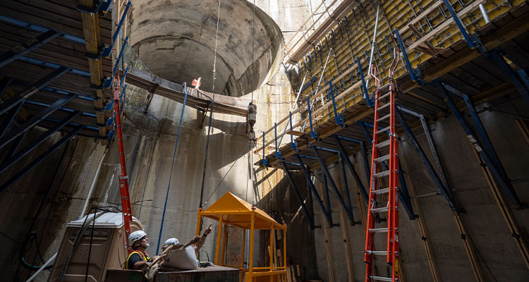construction workers in a deep concrete chamber