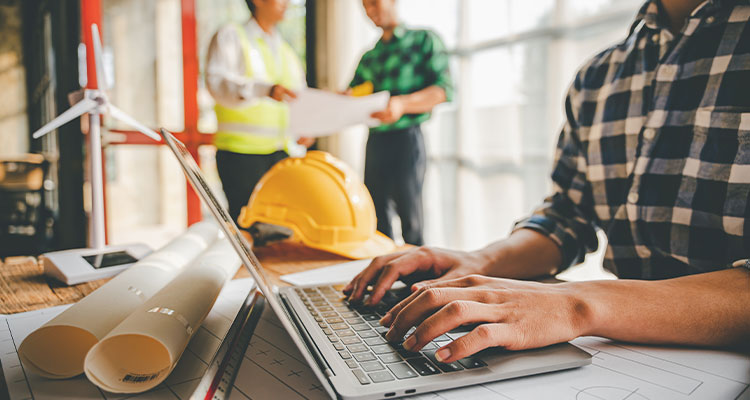 a construction or engineering work environment where professionals are collaborating and utilizing technology for project planning and management