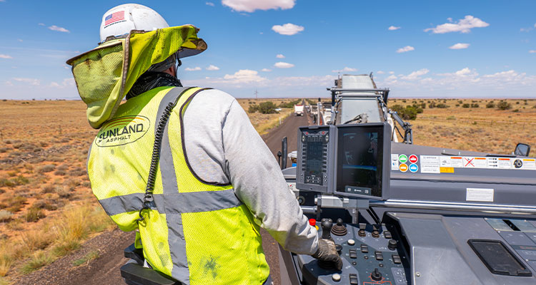 a worker operating an asphalt paver for Sunland Asphalt & Construction