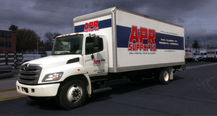 a white Hino box truck with prominent red and blue "APR Supply Co" branding on its side and cab door