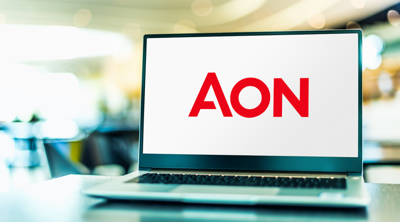 Laptop screen displaying the Aon logo in a modern office setting, representing the firm's launch of a new insurance facility for U.S. construction projects.