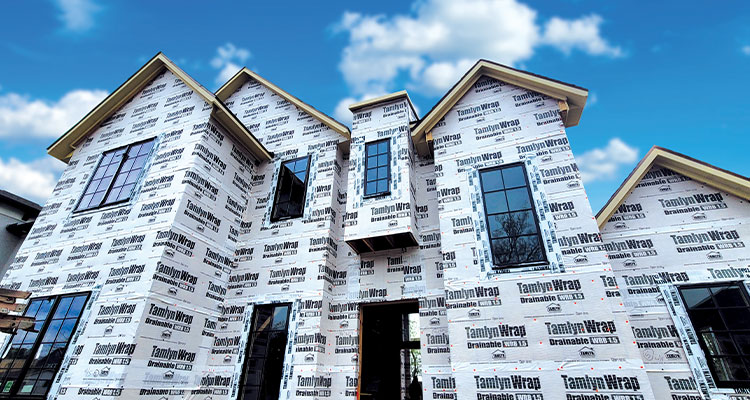 a house under construction wrapped in TamlynWrap Drainable Wrap