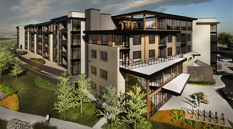 Modern four-story multifamily apartment building with mixed brick and panel façade, large glass windows, upper-level balconies, rooftop terrace, and landscaped walkways at sunset.