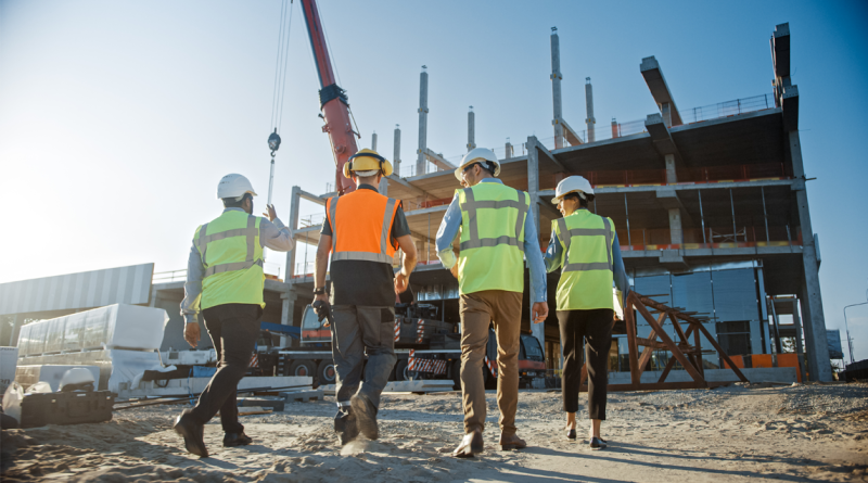 Diverse Team of Specialists Inspect Commercial, Industrial Building Construction Site